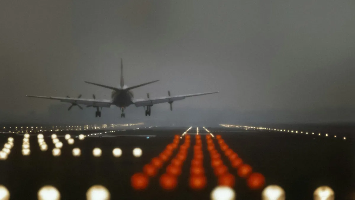 Approach lights glowing on a foggy runway at night